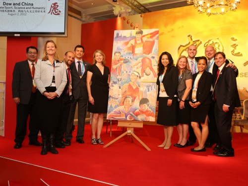   The OBE team posing with Greg’s painting