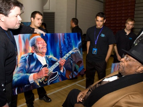   Greg backstage with B.B. King and Greg’s portrait of the King of Blues