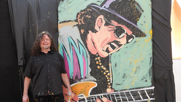Gregory Adamson next to finished Carlos Santana painting